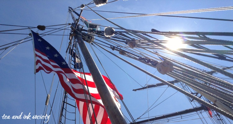 View from the deck of a tall ship, looking up at rigging and American flag