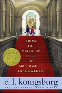 Book cover of From the Mixed-Up Files of Mrs. Basil E. Frankweiler by E. L. Konigsburg - children walking up red-carpeted stairs into the Metropolitan Museum of Art
