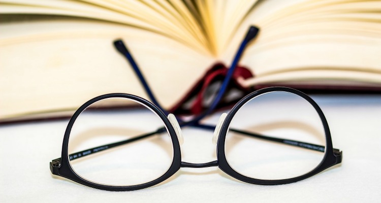 Reading glasses in front of an open book