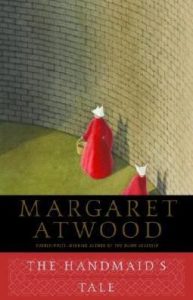 The Handmaid's Tale book cover - women in red robes walking beside brick wall