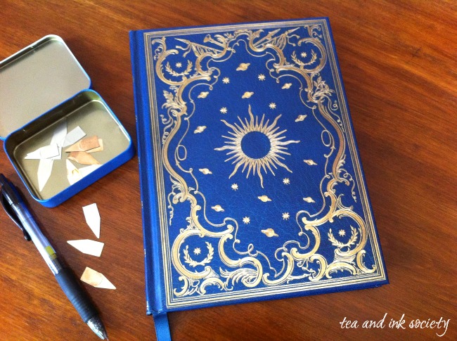 Blue and gold celestial pattern reading journal with tin of book darts