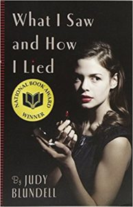 Book cover of "What I Saw and How I Lied" - sepia-tinted photograph of teenage girl putting on lipstick