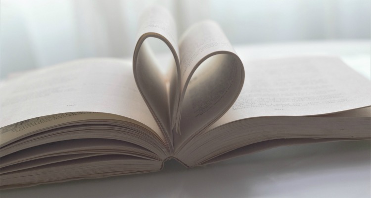 Open book with center pages folded into a heart shape