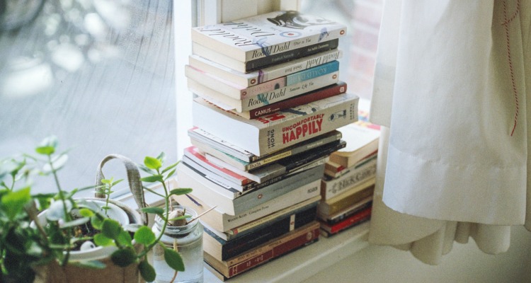 Stack of books on a pretty windowsill