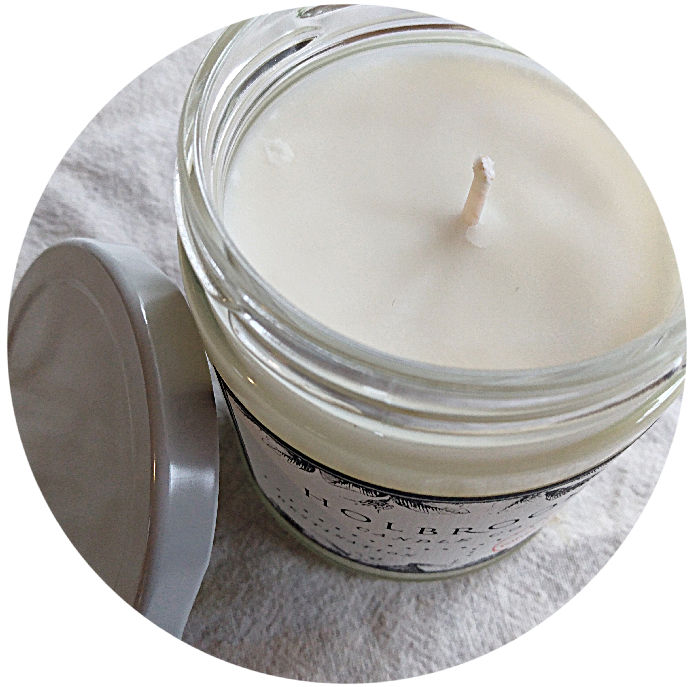 white candle in a glass jar