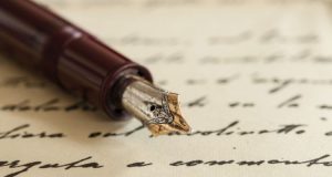 Old-fashioned fountain pen with cursive writing