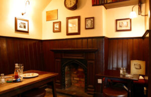 Eagle and Child pub interior - half-walled room with fireplace and Inklings memorabilia