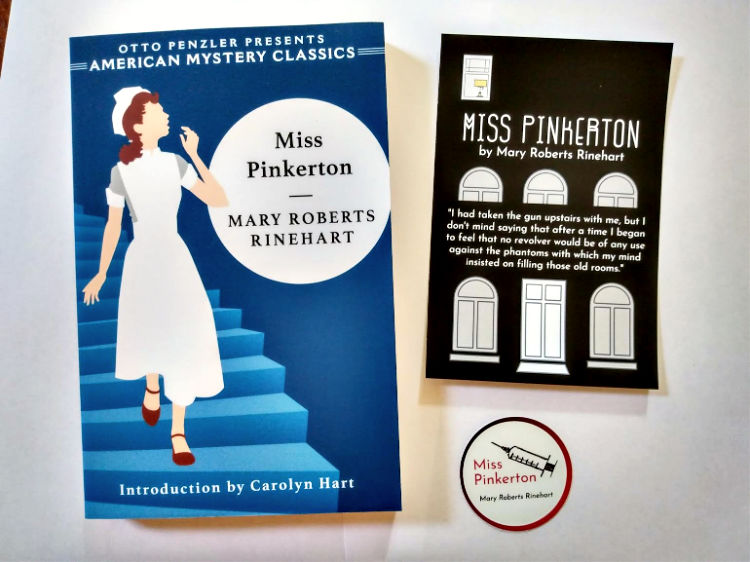 Blue and white paperback copy of Miss Pinkerton by Mary Roberts Rinehart, with postcard and sticker